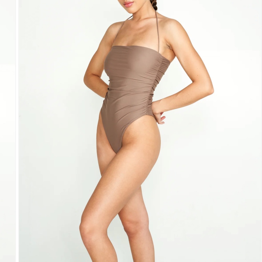 Never worn Nyud light brown one piece in a size small